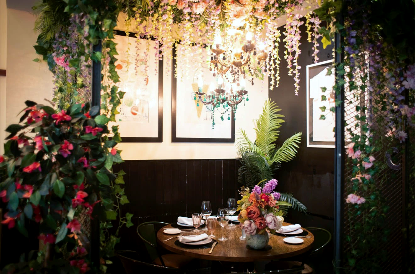 Rincón del comedor rodeado de flores y plantas